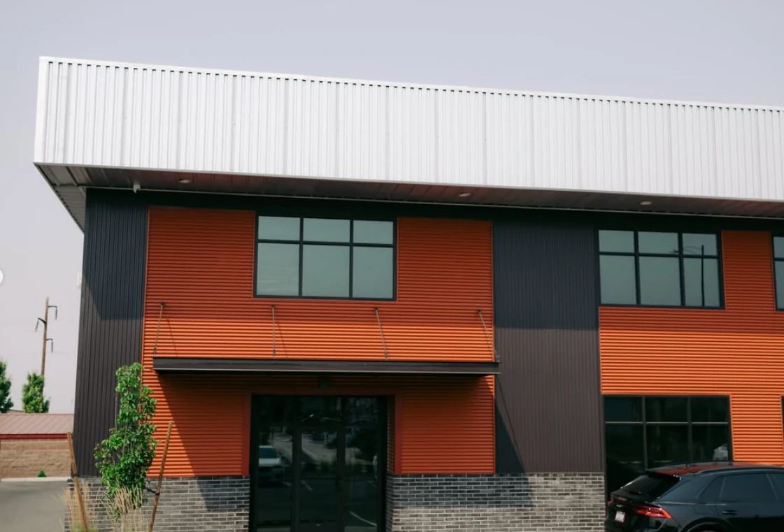 Orange and charcoal Broadmoor Commercial Center building entrance where THE90 is located
