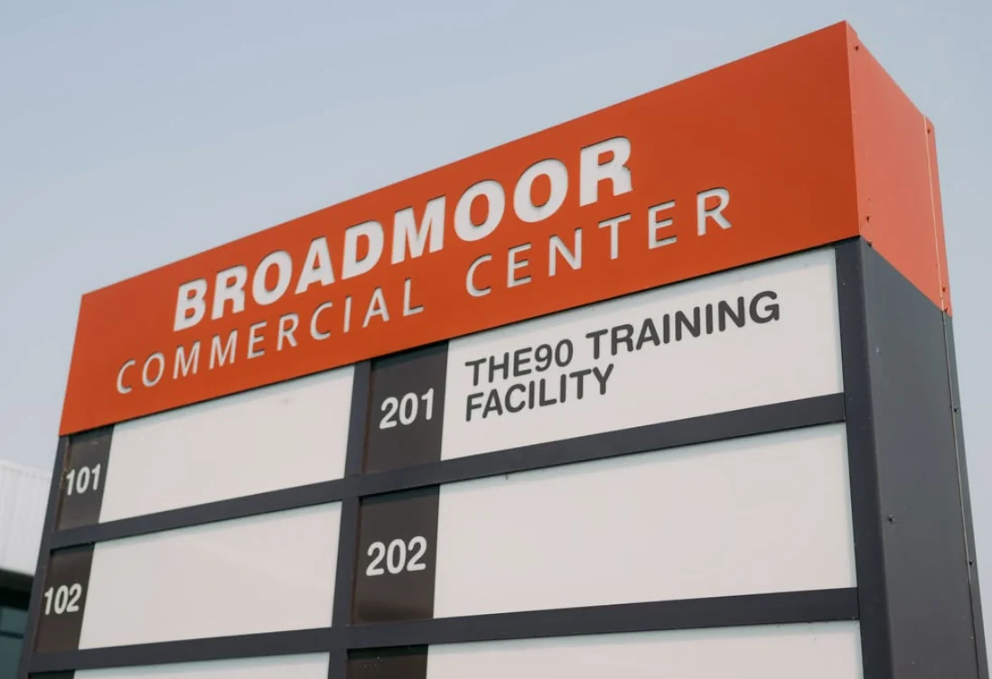 Broadmoor Commercial Center sign identifying THE90 Training Facility in suite 201