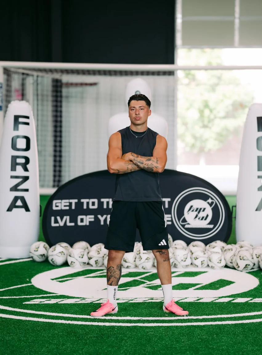 THE90’s owner standing arms crossed on the indoor turf in front of the goal